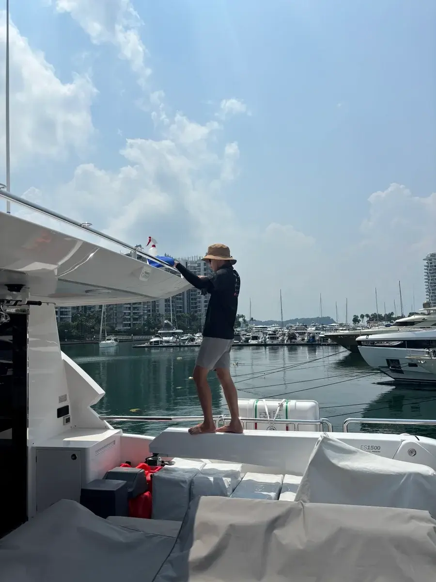 Worker wiping a yacht overhang