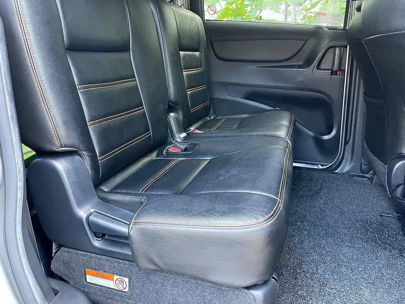 Clean rear seats with orange stitching