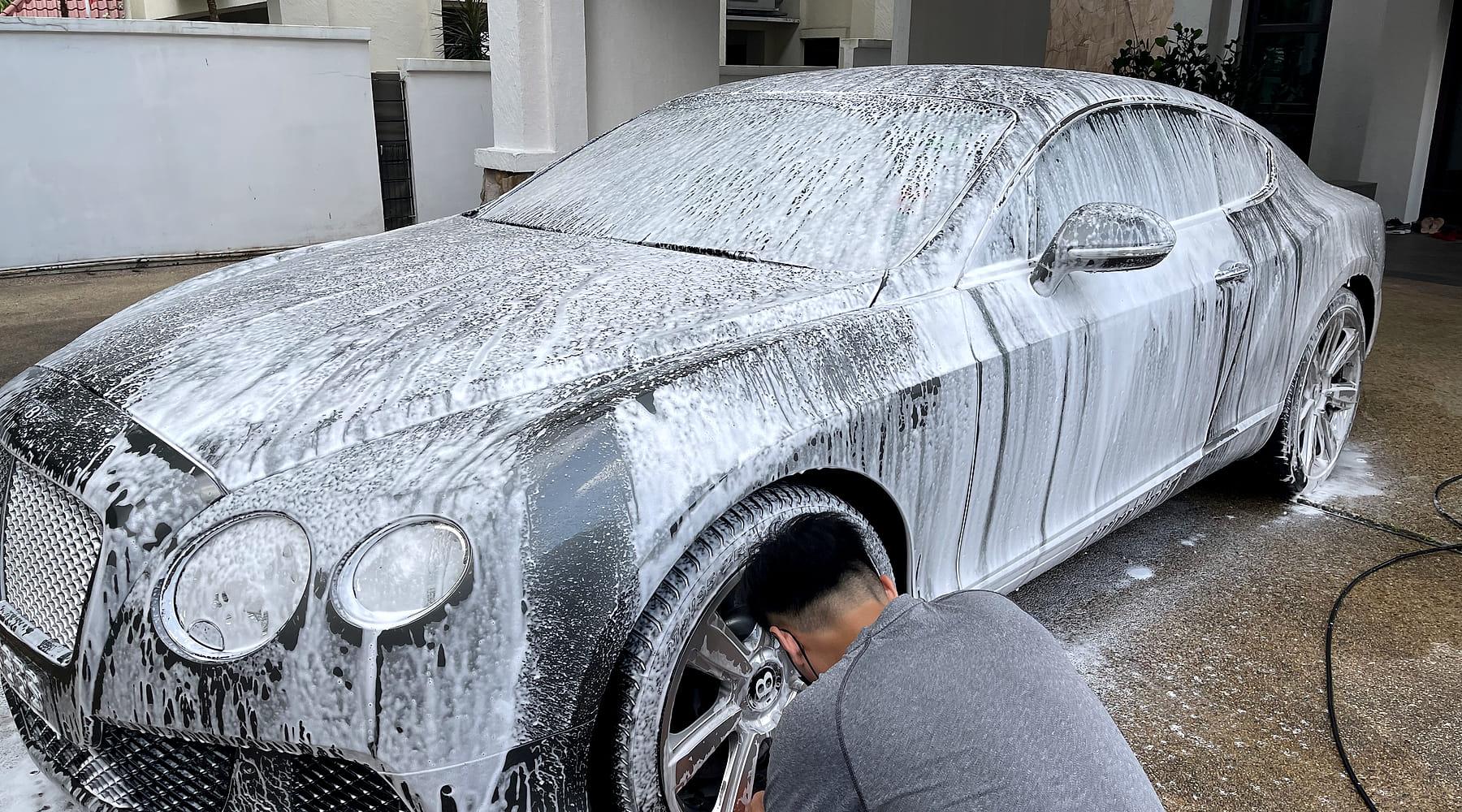 PA washing a foam-covered car at a customer’s home