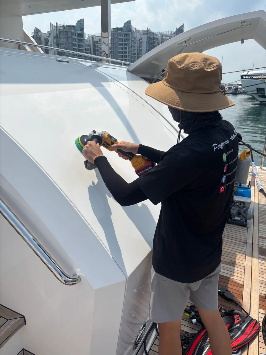 PA detailer polishing a yacht stern panel